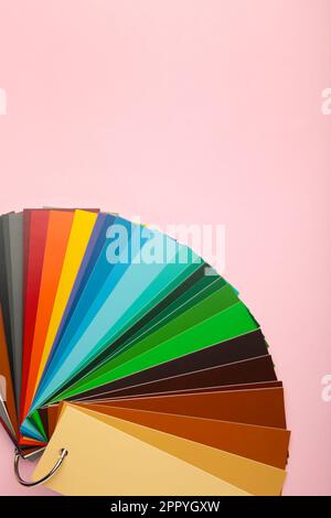 Colored cardboard palette, paper catalog on a pink background. Top view. Stock Photo
