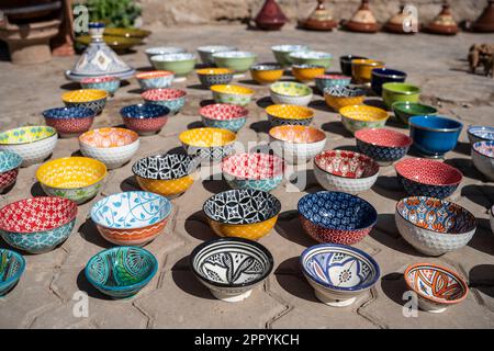 Colorful ceramic bowls displayed on the floor for sale. Stock Photo