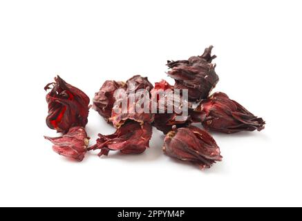 Hibiscus tea on a white background close-up. Dry flowers of red hibiscus on isolation. A handful of hibiscus for making tea. Stock Photo