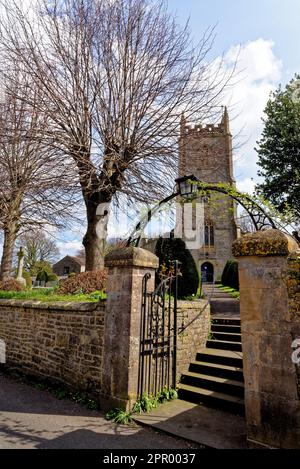 All Saints Church in the Village of Nunney in a sunny day, Somerset, England, United Kingdom - 8th of April 2023 Stock Photo