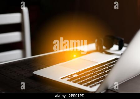 Laptop workspace mockup on dark background. Defocus home work pl Stock Photo