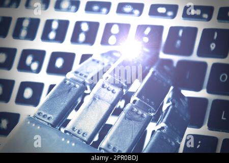 Hand of a robot while working on computer keyboard . Stock Photo