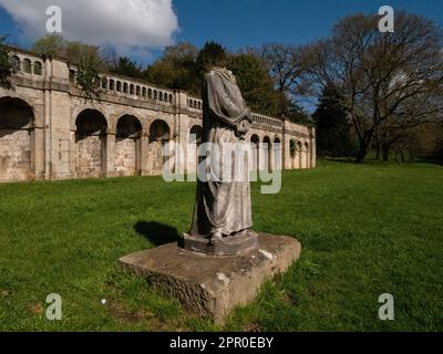 Dante, headless marble statue in Crystal Palace Park. First recorded in the park in 1864. 3/4 angle of full length figure against classical arches. Stock Photo