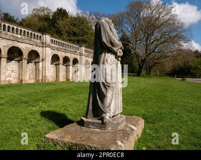 Dante, headless marble statue in Crystal Palace Park. First recorded in the park in 1864. 3/4 angle of full length figure against classical arches. Stock Photo