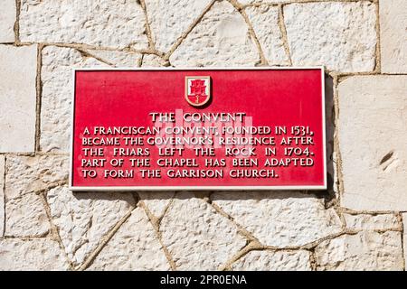 red Plaque with history of The Convent, Governors Residence and Kings Chapel garrison church. main Street,  The British Overseas Territory of Gibralta Stock Photo