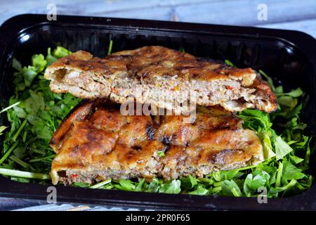 Traditional Egyptian dish Hawawshi, pita stuffed with minced meat and spiced with onions, pepper, parsely and chilies, baked by filling flat Egyptian Stock Photo