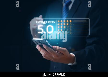 Businessman pressing smiley face emoticon on virtual screen Stock Photo