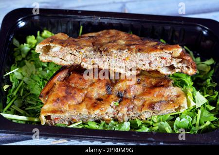 Traditional Egyptian dish Hawawshi, pita stuffed with minced meat and spiced with onions, pepper, parsely and chilies, baked by filling flat Egyptian Stock Photo