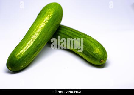 Freshly Picked, Close-up Photo of Two Crisp Cucumbers on a White Background Stock Photo
