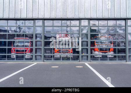 Fire brigade, fire station, modern station, glass gates, emergency vehicles standing in the vehicle hall, Cologne, NRW, Germany, Stock Photo