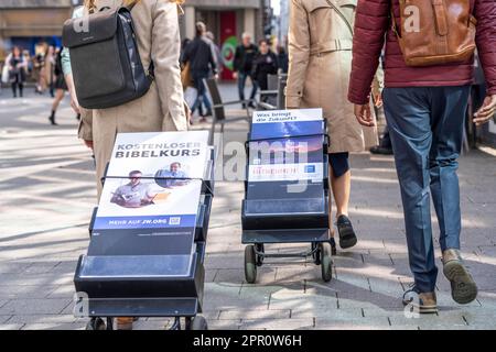 Jehovah's Witnesses with mobile information stands, with information in different languages, in the pedestrian zone near Cologne Cathedral, Stock Photo