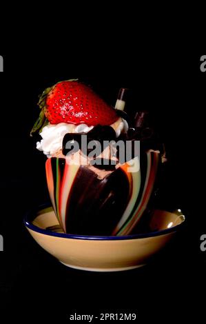 Chocolate and strawberry mouse isolated on black Stock Photo