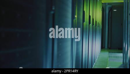 General view of empty server room with multiple black servers Stock Photo