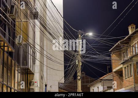 Electric pole wires in Prizren city by night Stock Photo