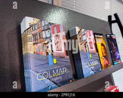 Basel, Switzerland - Sep 22, 2022: A modern airport stand offering a variety of travel brochures, books and newspapers written in western script for communication, information and news about the city of Colmar, France Stock Photo