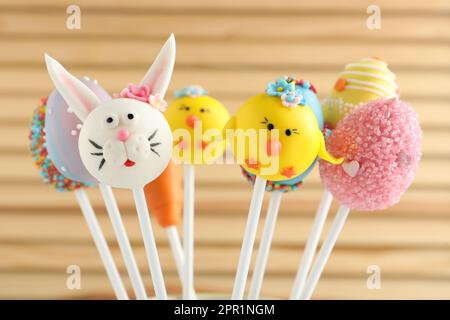 Different delicious sweet cake pops on wooden background. Easter holiday Stock Photo