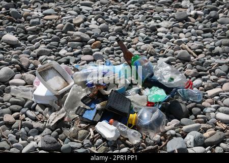 Pile of garbage on stones outdoors. Environmental Pollution concept ...