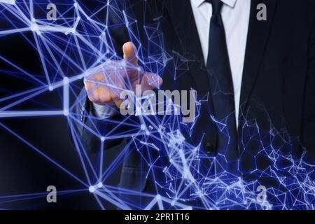 Man using virtual screen with connection lines presenting innovation network linkage on dark background Stock Photo