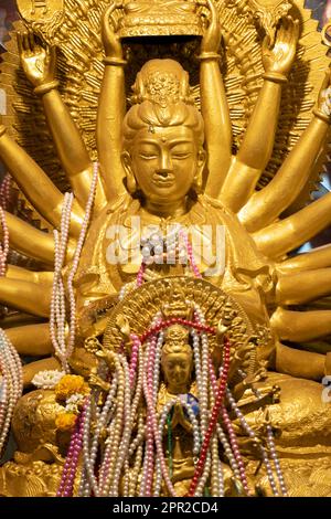 Golden statue of  Quan Yin 'Goddess of Mercy' in Buddhist temple, Thailand Stock Photo