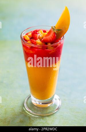 Glass of fresh mango and strawberry smoothie Stock Photo