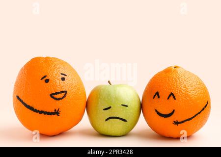 Cute orange and apple fruits on beige background. Friendship Day celebration Stock Photo