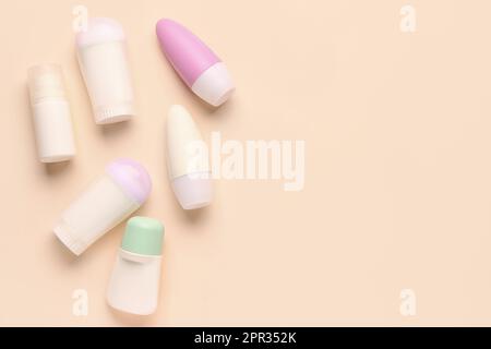 Different deodorants on beige background Stock Photo