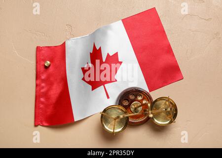 Flag of Canada with justice scales on beige background Stock Photo