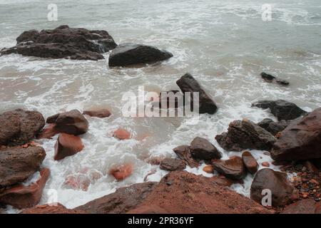 Close-up of red sand, stones, and rocks in Legzira Beach. Rugged