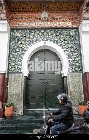 Motorcycle passing in front of the gate of the Grand Mosque of Tanger. Stock Photo