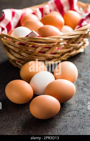 Whole chicken eggs on the black table. Stock Photo