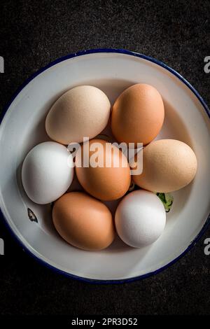 Whole chicken eggs in the bowl. Top view. Stock Photo