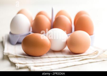 Whole chicken eggs on the kitchen napkin. Stock Photo