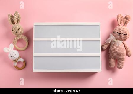 Blank letter board and different toys on pink background, flat lay. Mockup for design Stock Photo