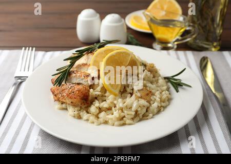 Delicious chicken risotto with lemon slices on table Stock Photo