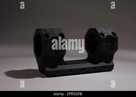 Quick disconnect sniper cantilever scope mount on grey background Stock Photo