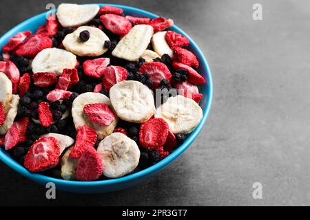 Bowl of dried fruits on grey table, closeup. Space for text Stock Photo