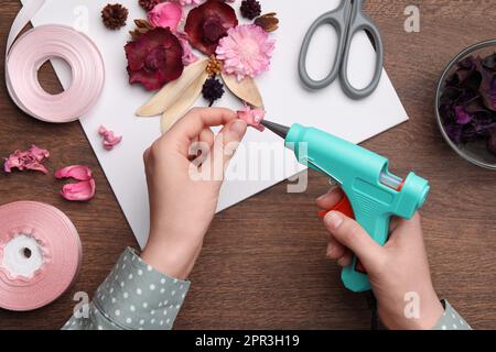 Woman make floral decor with melt glue gun Stock Photo - Alamy