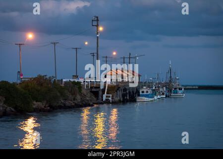 Fishing boats moored alongside Holmes Wharf at night, Oamaru harbour, North Otago, South Island, New Zealand Stock Photo