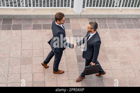 Successful teamwork. Business people shaking hands. Businessmen in suit shaking hands outdoors. Handshake between two businessmen. wo business men had Stock Photo