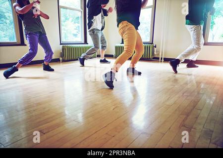 Get moving, get grooving. a group of people dancing together in a studio. Stock Photo