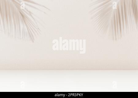 Product placement background with palm leaves shadow on beige cement wall texture. Empty palm shadow brown color pattern on wall background. Summer tr Stock Photo