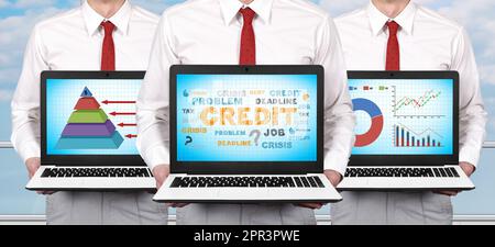 Three businessman standing in office and holding laptop with business development concept on screen Stock Photo