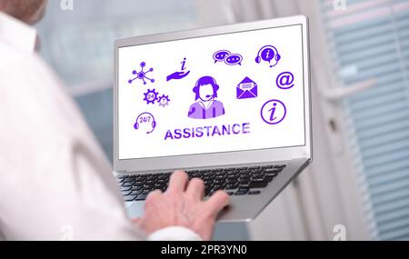 Assistance concept shown on a laptop used by a man Stock Photo