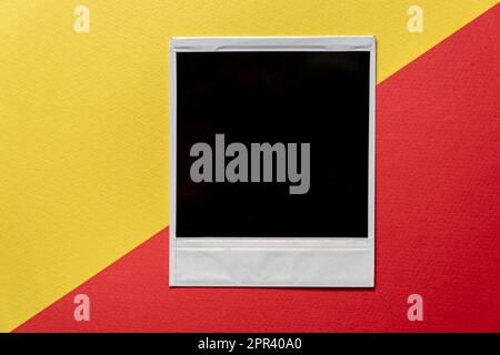 Download Blank photo frame template on red and yellow background. Blank square photo frame on wall copy space Stock Photo