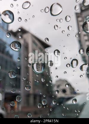 A closeup shot of water droplets running down the window from the inside of the vehicle. Stock Photo