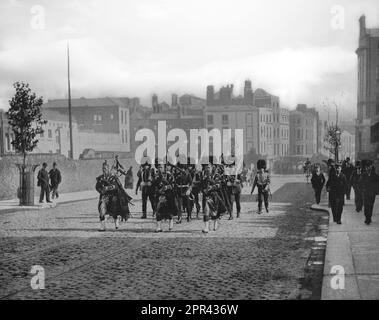 A late 19th century photograph of the Scots Guards of the British Army marching through Dublin City, Ireland. Being fellow Celts, they were more popular with locals than other army regiments. Stock Photo