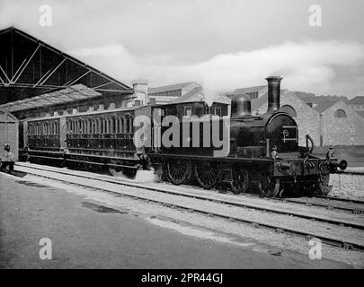 A late 19th century photograph of  steam locomotive pulling passenger coached out of Heuston Station. Stock Photo