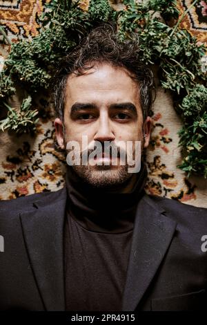a young male executive surrounded by marijuana buds and calling for the legalization of cannabis. Drug concept Stock Photo
