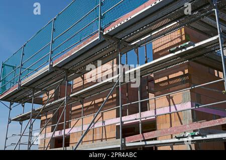 Massive home in shell construction with scaffolding Stock Photo