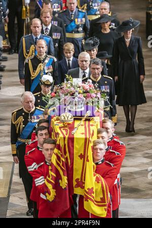 File photo dated 19/09/22 of King Charles III, the Queen Consort, the Princess Royal, Vice Admiral Sir Tim Laurence, the Duke of York, the Earl of Wessex, the Countess of Wessex, the Prince of Wales, the Princess of Wales, Prince George, Princess Charlotte, the Duke of Sussex, the Duchess of Sussex, Peter Phillips and the Earl of Snowdon follow behind the coffin of Queen Elizabeth II, draped in the Royal Standard with the Imperial State Crown and the Sovereign's orb and sceptre, as it is carried out of Westminster Abbey after her State Funeral. Issue date: Wednesday April 26, 2023. Stock Photo